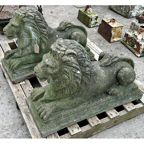 150 - Pair of weathered reconstituted stone recumbent lions with chamfered plinths, H 50cm x W 73cm x D 30... 