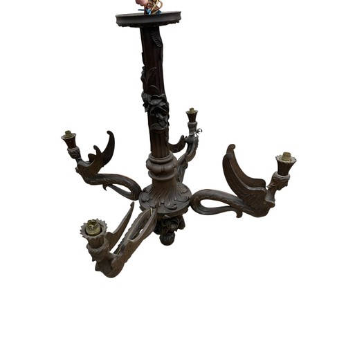 30 - A large early 20th century Swiss Black Forest carved wooden four-arm electrolier, the branches model... 