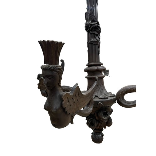 30 - A large early 20th century Swiss Black Forest carved wooden four-arm electrolier, the branches model... 
