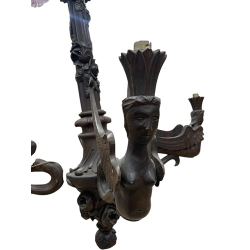 30 - A large early 20th century Swiss Black Forest carved wooden four-arm electrolier, the branches model... 