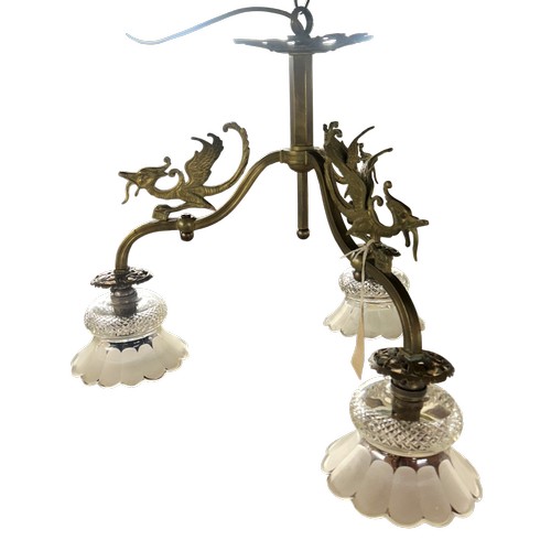 50 - Early 20th Century brass ceiling light, the three arms surmounted by winged mythical creatures, each... 