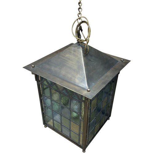 40 - A large and impressive square lantern with stained glass leaded panels, decorated with rams head mot... 