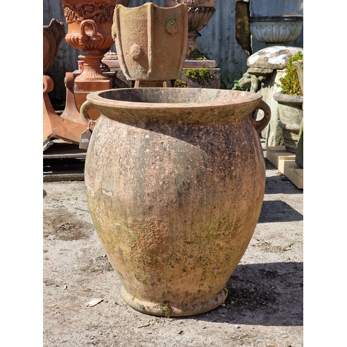 125 - Weathered terracotta twin handled amphora urn, H 69cm x W 55cm
