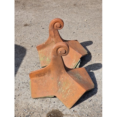 130 - Pair of terracotta roof tiles with scrolled finials, stamped Bridgwater, H 45cm x W 54cm x D 48cm (2... 