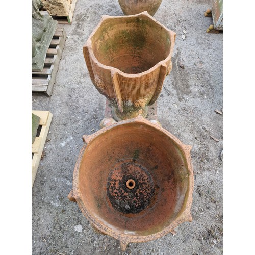 131 - Pair of two sectional terracotta urns with textured roundels and incised detail,