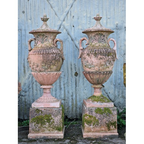 136 - Pair of large 20th century composite terracotta lidded garden urns with foliate and grape vine relie... 