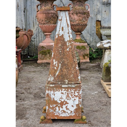 127 - Terracotta obelisk of tapered form raised on a square cut base with fielded sides and ball finial su... 