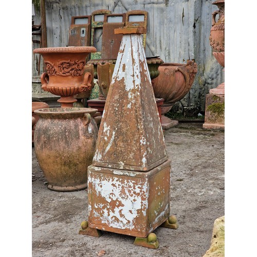 127 - Terracotta obelisk of tapered form raised on a square cut base with fielded sides and ball finial su... 