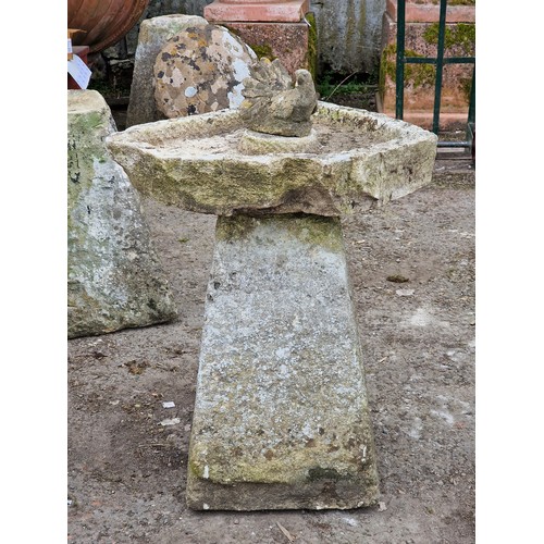 149 - Weathered rustic natural stone bird bath with composite bird decoration, H 71cm x W 60cm x D 64cm