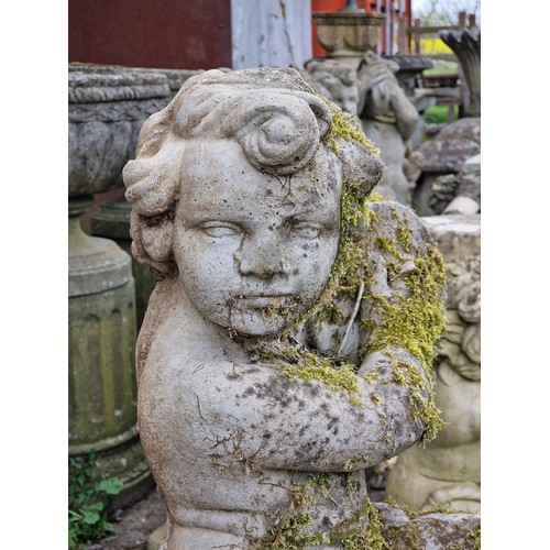 158 - Well weathered reconstituted stone garden statue of a musical cherub seated on a ball pier cap playi... 