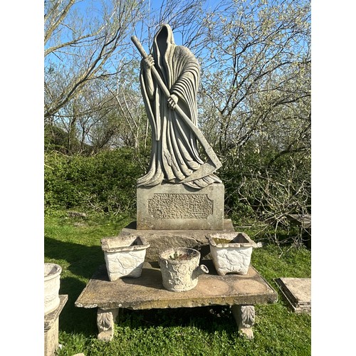670 - Remarkable and large hand carved natural stone carving of the Grim Reaper with good detail, on subst... 