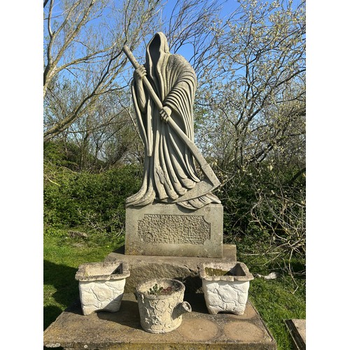 670 - Remarkable and large hand carved natural stone carving of the Grim Reaper with good detail, on subst... 
