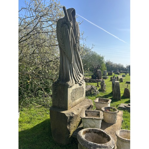 670 - Remarkable and large hand carved natural stone carving of the Grim Reaper with good detail, on subst... 