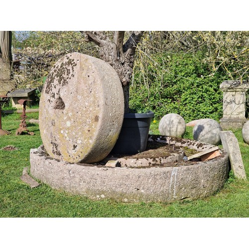 672 - Monumental antique natural stone cider press and mill stone, the base 250cm dia, the mill stone 130c... 