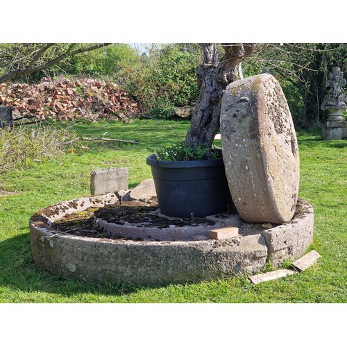 672 - Monumental antique natural stone cider press and mill stone, the base 250cm dia, the mill stone 130c... 