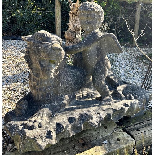 677 - Impressive antique York stone sculpture of a cherub and recumbent lion, H 90cm x W 125cm

Situated a... 