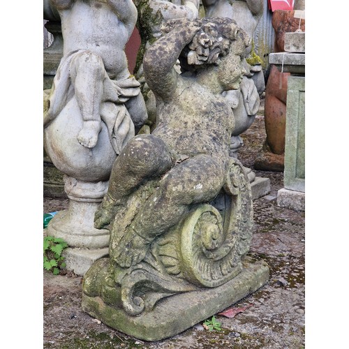 155 - Weathered reconstituted stone garden statue of a seated cherub clutching a bundle of flowers, H 76cm... 