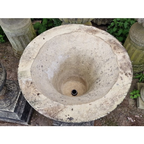 166 - Pair of weathered reconstituted stone garden urns with flared rims and chamfered square cut plinths,... 
