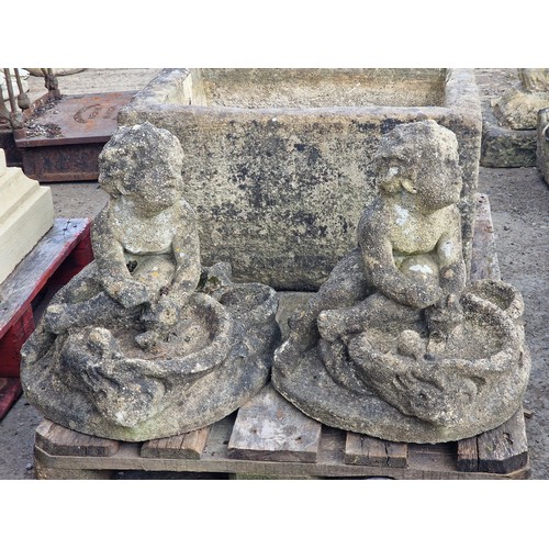 178 - Pair of weathered reconstituted stone garden bird baths in the form of seated cherubs with shell sha... 