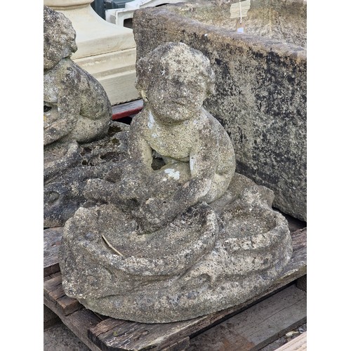 178 - Pair of weathered reconstituted stone garden bird baths in the form of seated cherubs with shell sha... 