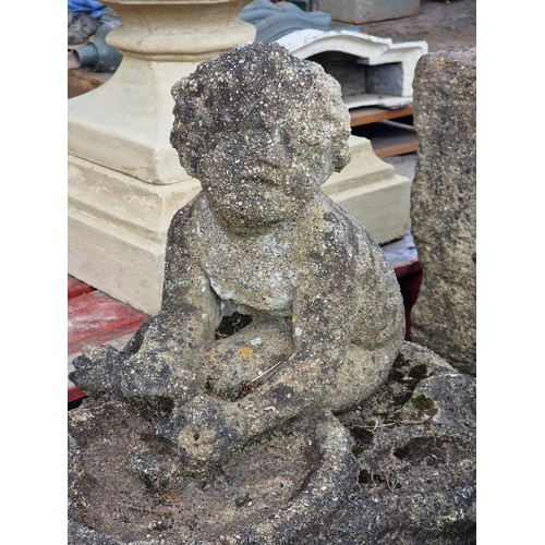 178 - Pair of weathered reconstituted stone garden bird baths in the form of seated cherubs with shell sha... 