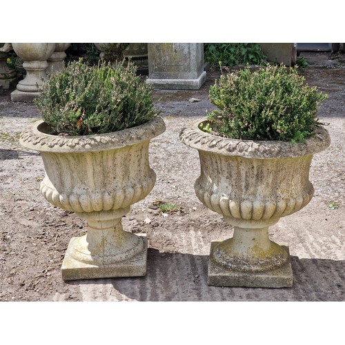 175 - Pair of weathered reconstituted stone garden urns with lobed bowls and acanthus leaf detail, H 47cm ... 