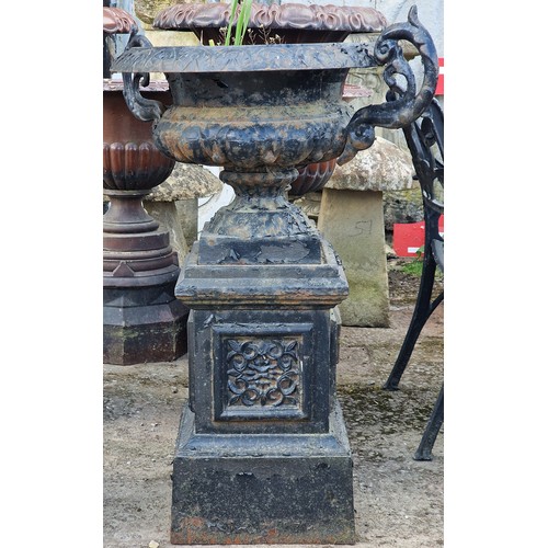 174 - Antique painted cast iron urn with ornate scrolled handles and lobed bowl, raised on a square plinth... 