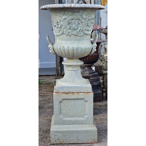 173 - After Andrew Handyside - Antique cast iron garden urn with scrolling floral relief and face mask det... 