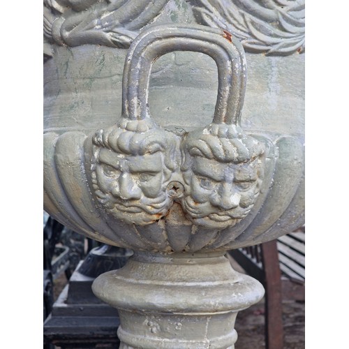 173 - After Andrew Handyside - Antique cast iron garden urn with scrolling floral relief and face mask det... 