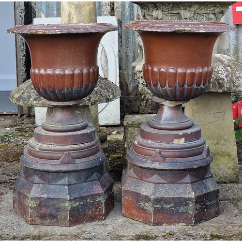 171 - Pair of salt glazed garden urns with lobed bowls and flared darted rims, raised on octagonal plinths... 