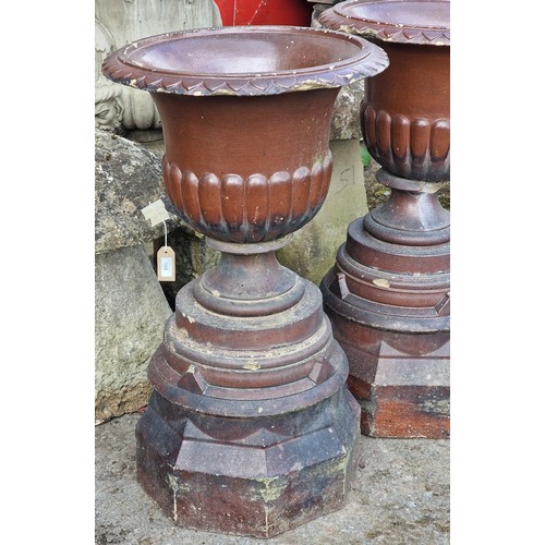 171 - Pair of salt glazed garden urns with lobed bowls and flared darted rims, raised on octagonal plinths... 