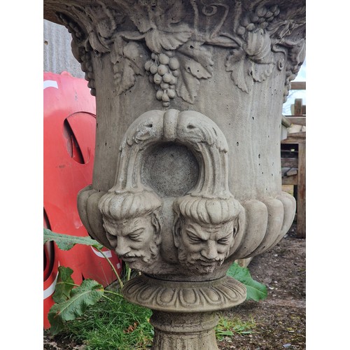 168 - Large reconstituted stone garden urn with fruiting grape vine relief, egg and darted rim and face ma... 
