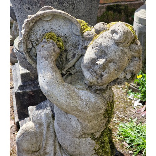160 - Pair of weathered reconstituted stone garden statues of musical cherubs seated on ball pier caps, on... 
