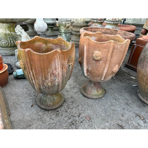 131 - Pair of two sectional terracotta urns with textured roundels and incised detail,