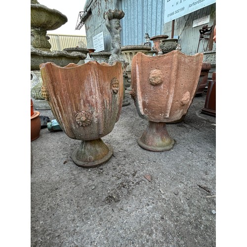 131 - Pair of two sectional terracotta urns with textured roundels and incised detail,