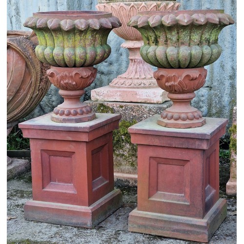 135 - Pair of antique terracotta effect garden urns with lobed bowls and spiked rims, raised on octagonal ... 