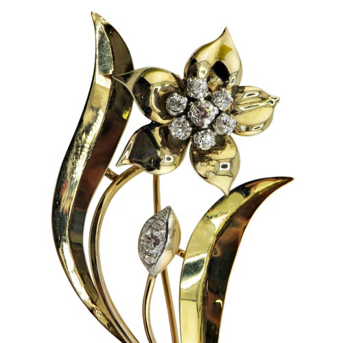 9 - A vintage diamond floral spray brooch set with a flower-head cluster of seven old-cut diamonds and a... 
