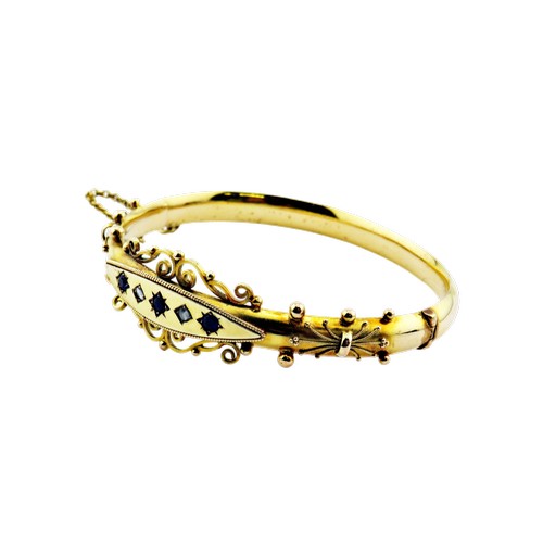 14 - A late Victorian gold sapphire and rose diamond hollow hinged bangle, set with three sapphires and t... 