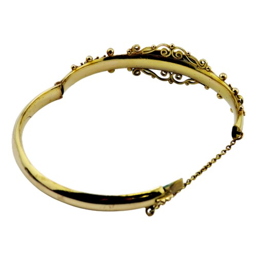 14 - A late Victorian gold sapphire and rose diamond hollow hinged bangle, set with three sapphires and t... 