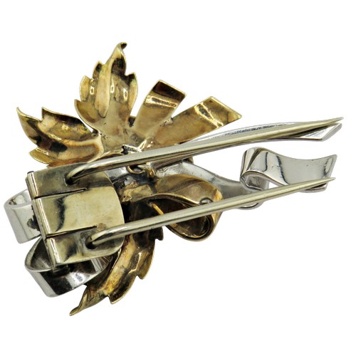 18 - A mid 20th century tri-colour gold, ruby and diamond clip brooch, the central rose-coloured flower-h... 