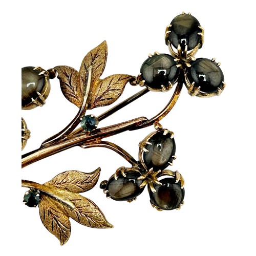 19 - A vintage Continental black sapphire flower stem spray brooch, set with nine oval black sapphire cab... 