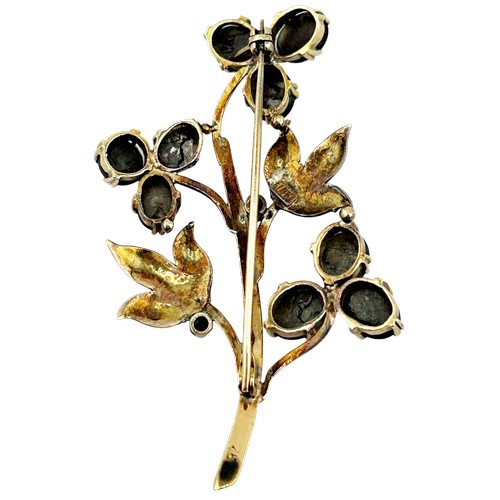 19 - A vintage Continental black sapphire flower stem spray brooch, set with nine oval black sapphire cab... 