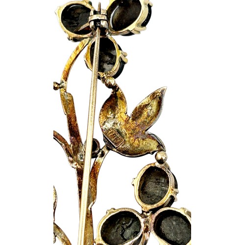 19 - A vintage Continental black sapphire flower stem spray brooch, set with nine oval black sapphire cab... 