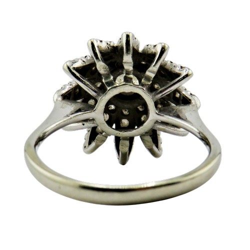 36 - An 18ct white gold and diamond flower-head cluster ring, centred with a round brilliant approx. 0.25... 