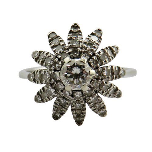 36 - An 18ct white gold and diamond flower-head cluster ring, centred with a round brilliant approx. 0.25... 
