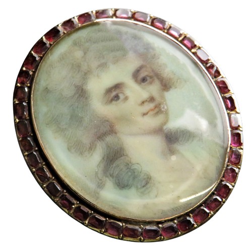 120 - A 19th century gold, flat-cut garnet and portrait miniature oval panel later adapted as a brooch wit... 