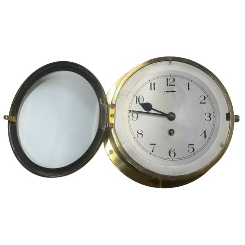 617 - An early 20th century maritime brass cased ships bulkhead clock, silvered dial with Arabic numerals ... 