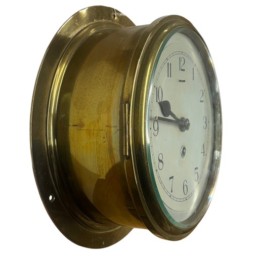 617 - An early 20th century maritime brass cased ships bulkhead clock, silvered dial with Arabic numerals ... 