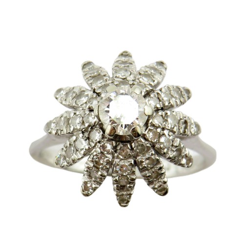 36 - An 18ct white gold and diamond flower-head cluster ring, centred with a round brilliant approx. 0.25... 