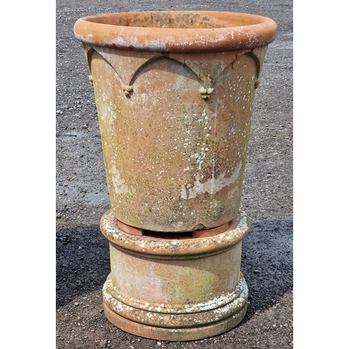 9 - Three large Italian terracotta planters with Gothic arch detail raised on circular terracotta plinth... 